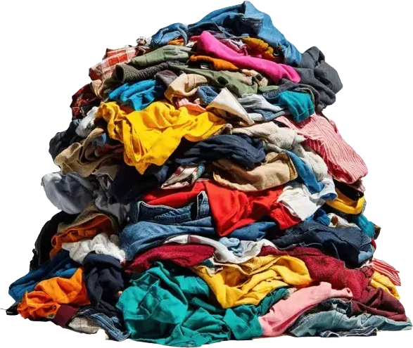 A towering pile of discarded clothing in a landfill