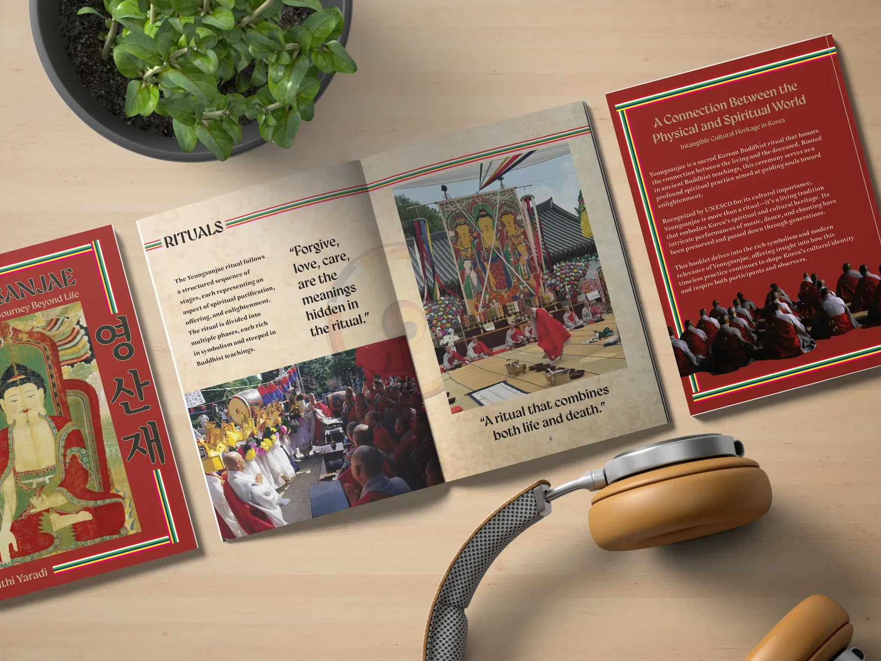 The booklet open on a light wooden desk beside headphones and a plant